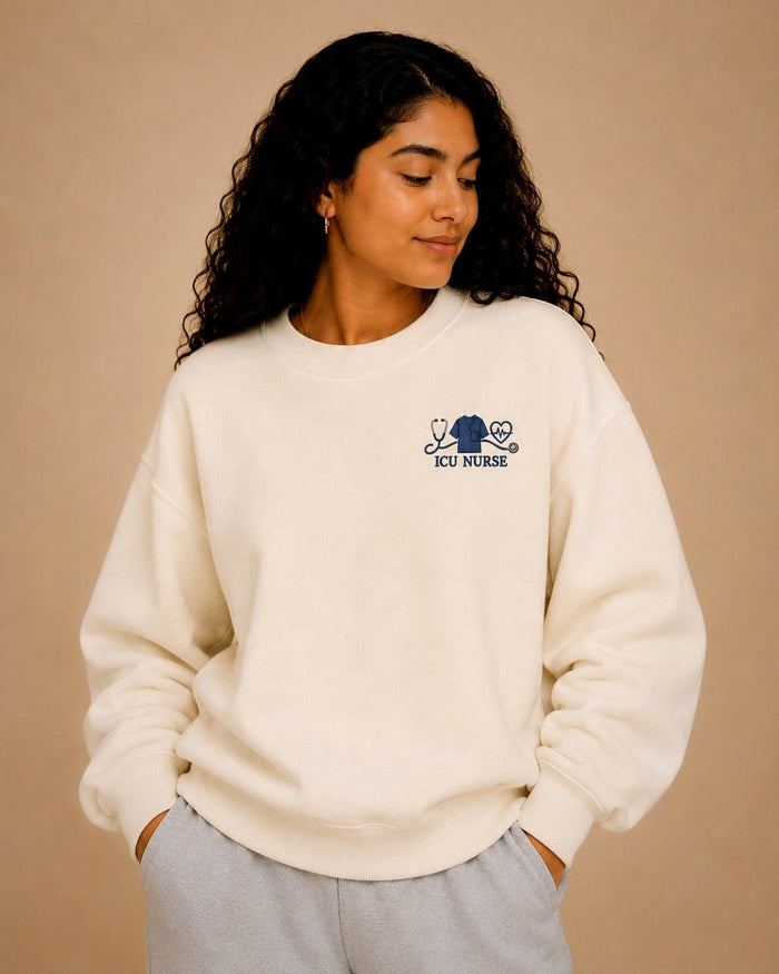 ICU Nurse crewneck worn, navy embroidered chest design